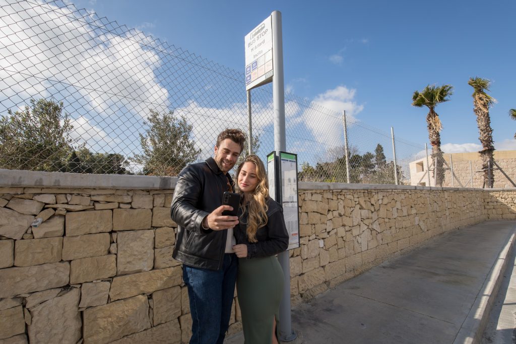 Couple waiting at bus stop