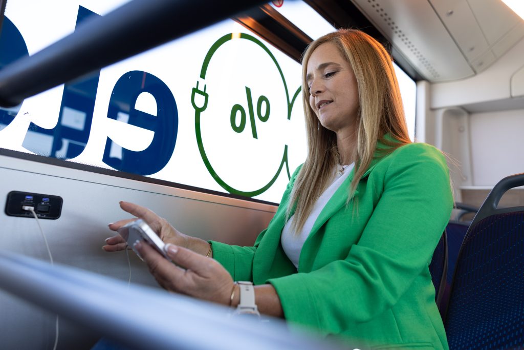 Woman using phone on Bus