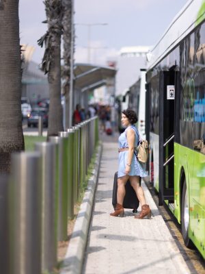 woman leaving bus towards airport