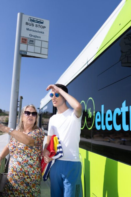 people leaving bus looking at beach
